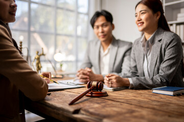 A woman and a man are sitting at a table with a judge