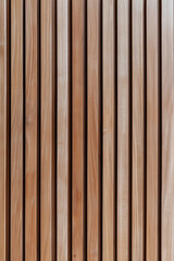 Obraz premium Vertical wood slats create a warm and textured surface, perfect for architectural designs and backgrounds.