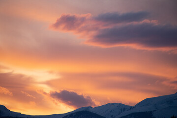 soft hues over the rocky mountains at sunset