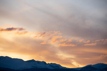 soft hues over the rocky mountains at sunset