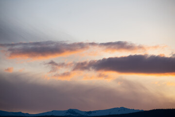 soft hues over the rocky mountains at sunset