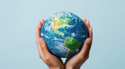 Hands Holding Earth Globe on Light Blue Background