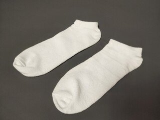 baby socks on black background