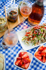Rose wine and gourmet food platter celebrating summer picnic