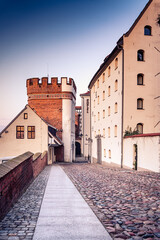 cobblestone streets of Torun, a charming UNESCO World Heritage site in Poland at dusk