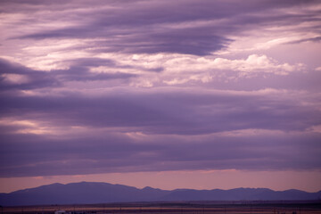dark clouds stretching out over the plains at last light