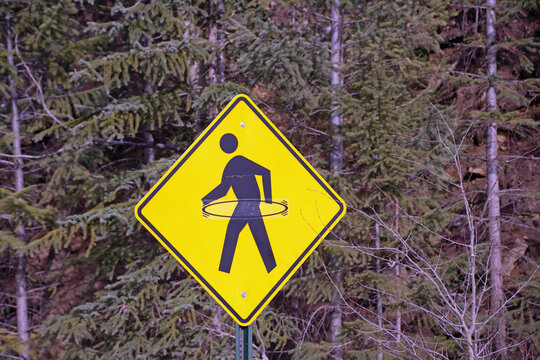 Pedestrian crossing sign with a hula-hoop sticker 