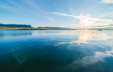 Catamaran Sailing On Calm Morning Waters