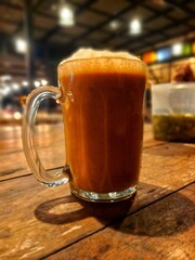 Teh Tarik – Malaysia's iconic tea, rich, frothy, and full of flavor, served hot in a classic glass mug