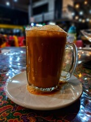 Savor the rich and creamy taste of Teh Tarik, Malaysia’s beloved tea, perfectly frothed for a smooth and aromatic experience