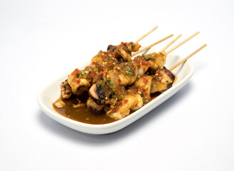 Grilled fresh squid on a stick, served with spicy sauce
