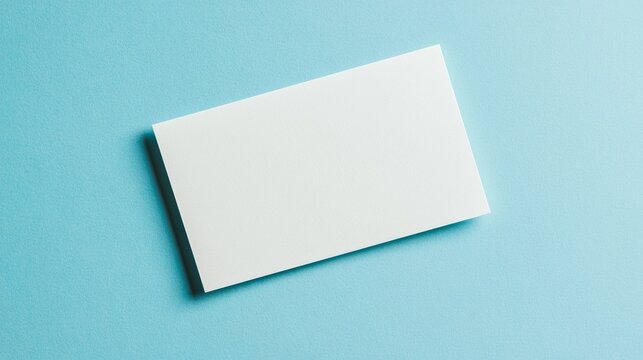 Blank white card on a flat surface, symbolizing simplicity and clarity in design.