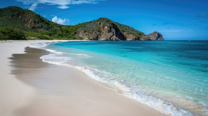 Turquoise Ocean Waves on Sandy Beach with Lush Green Hills Backdrop