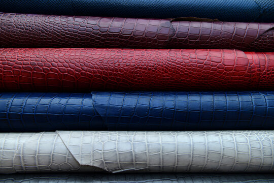 stack of Rolled leather sheets in various colors and textures.