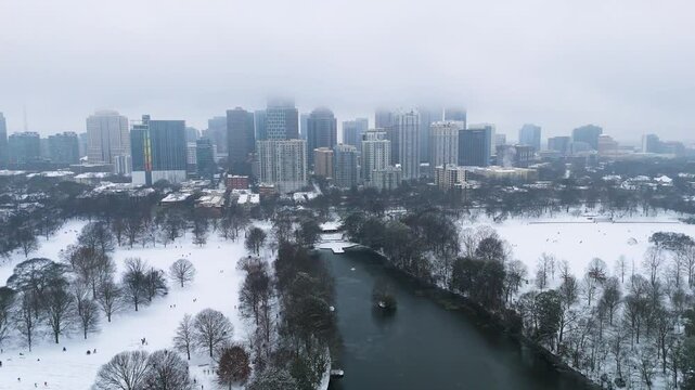 Aerial shot pulling out from snow covered Midtown and Piedmont Park in Atlanta on January 10th 2025.