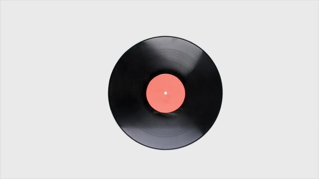 Vinyl record spinning animation white background. Vinyl retro record on DJ turntable record player.
Close-up of a vinyl record with a vibrant pink and blue label. Vinyl record for music storage