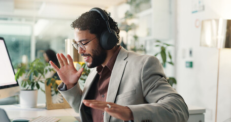 Business, energy and man with headphones, celebration and achievement with bonus. Person, employee and consultant with promotion, smile and headset for song, listening to music and email for approval