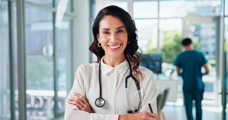Healthcare, doctor and woman in portrait with arms crossed, about us or professional career with smile. Hospital, mature cardiologist and leadership with confidence for medical help, service or pride