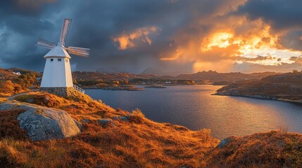 Fototapeta premium Dramatic sunset over a windmill by the water coastal landscape nature photography scenic view