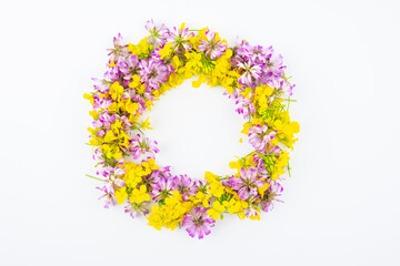Beautiful wreath made of rapeseed and astragalus flowers