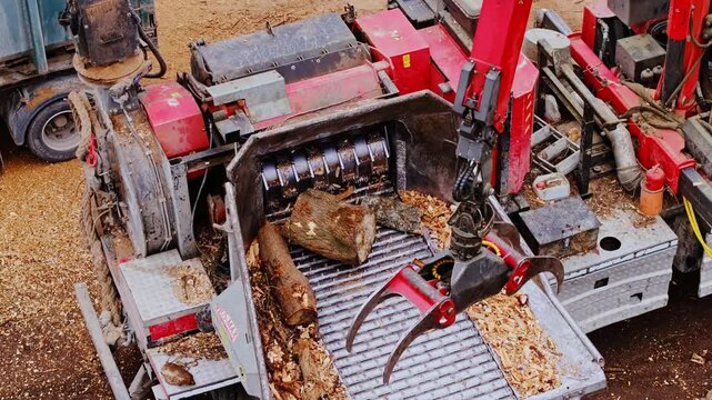 Wood chipper efficiently processes logs into fine wood chips, an industrial site