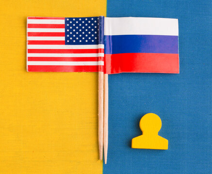 US and Russian flags on the Ukrainian flag.Concepts of negotiations between the two countries and peace