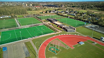 Sportpark with soccer fields and running track aerial drone view from above, football and athletic stadium bird’s view, sport and fitness infrastructure facilities in the Netherlands © Iuliia Sokolovska