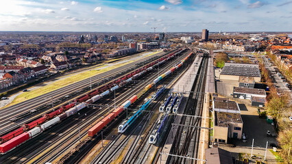 Railroad, train tracks and trains aerial drone view from above, railway station in the Netherlands,...