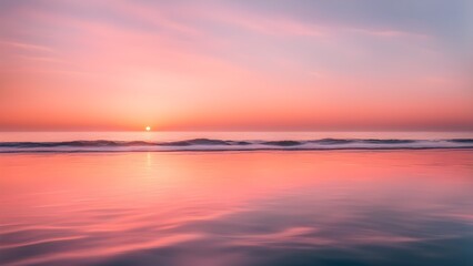 Obraz premium Peaceful ocean sunset reflecting vibrant pink orange hues calm waters.