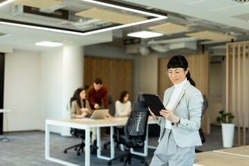 Fototapeta premium Business professionals collaborate in a modern office setting with technology at their fingertips