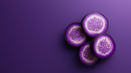 Purple Food and Drink A sliced eggplant with visible seeds and texture, vibrant purple color against a contrasting background.