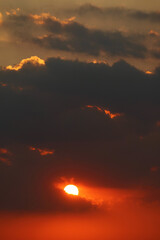 Stunning bright shining on the orange red cloudy sky	
