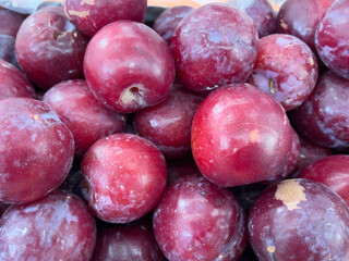 Fresh plums for sale at the farmers market. Close up.
