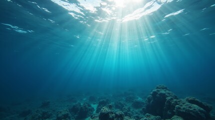 Underwater scene with sun rays shining through clear blue ocean water, illuminating coral reef and marine life in tropical sea