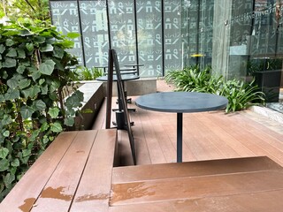 Outdoor bench in a green public open space environment, placed in city centre 