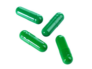Bulk green capsule pills isolated on white background.