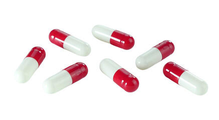 Bulk red and white capsule pills isolated on white background.