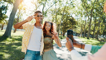 Happy, peace sign and couple in park for photograph together for love, bonding or relationship in summer. Fashion, social media influencer or man with woman in nature for picture, vacation or holiday