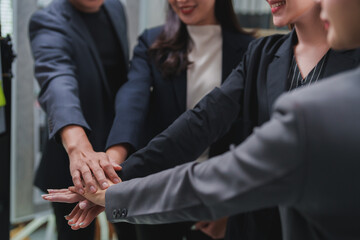 Business team joining hands for teamwork and cooperation concept