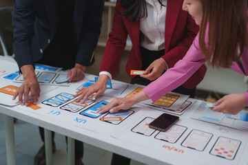 Fototapeta premium Designers working on ux ui design of mobile application during meeting
