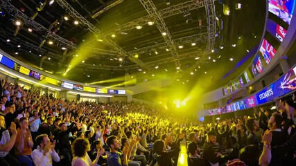Enthusiastic crowd applauding at event in arena