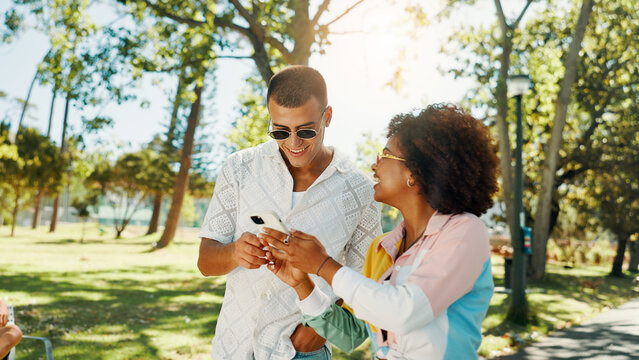 Couple of friends, mobile and happy outdoor for social media post, online blog and reading text message. Phone, gen z man and woman at park together for internet, communication and show video on app