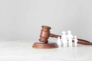 Figures of family with judge's gavel on light table