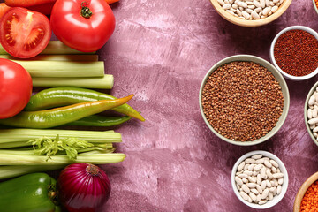 Different fresh vegetables and cereals on purple background