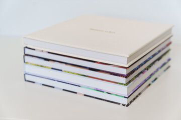 Wedding Album in gold letters on leather cover of book on books with photo cover