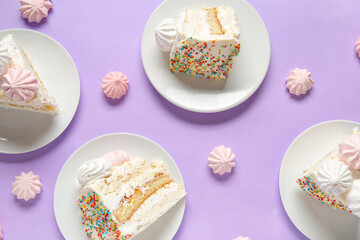 Plates with pieces of yummy Birthday cake and meringue on lilac background