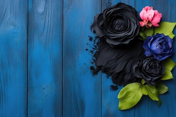 Dark floral arrangement on a vibrant blue wooden background