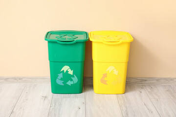 Containers for garbage near beige wall. Recycling concept