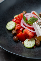 A colorful assortment of ripe tomatoes, crisp cucumbers, and briny olives is elegantly arranged, garnished with fresh herbs, highlighting the freshness of European culinary delights