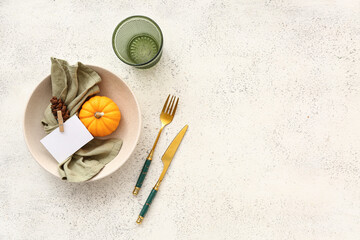 Autumn table setting with pumpkin and cone on white background